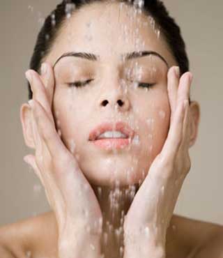 Teenage girl washing face